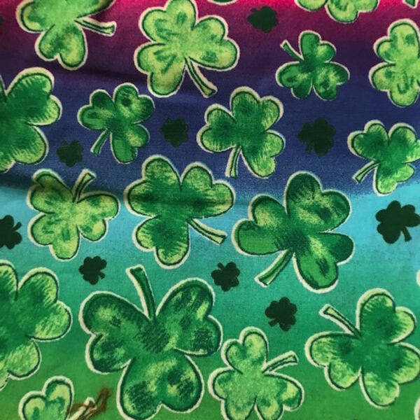 green clover on rainbow fabric