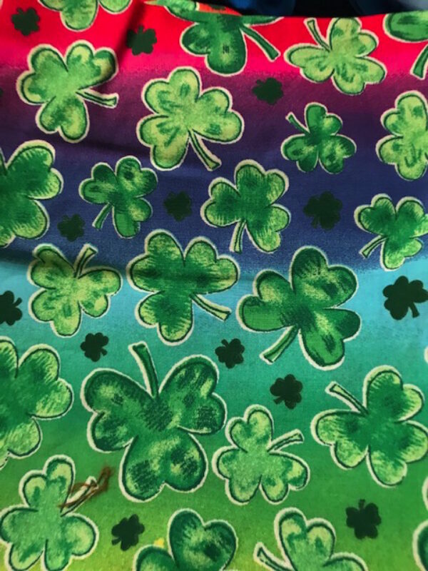 green clover on rainbow fabric